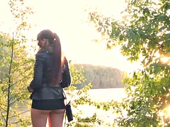 Eccentric redhead shows off her assets in public park