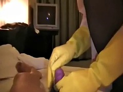 Asian nurse in yellow rubber gloves jerks off
