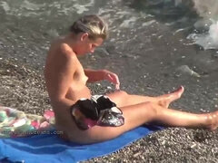 Nude girls are having tons of joy on the beach, while some people are gawping at them