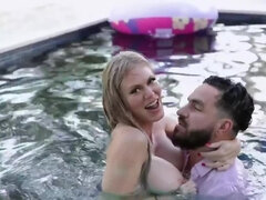 Busty blonde MILF and horny stud have fun in swimming pool