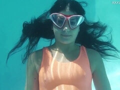 Flexible brunette babe Micha shows off her gymnastics skills underwater