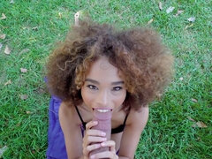 Curly haired teenie with beautiful smile sucks hard pecker outdoors