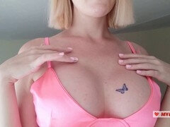 Applying temporary tattoos on her massive breasts and near pussy