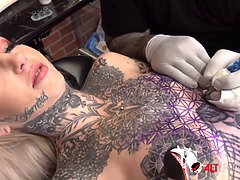 Sascha plays with Amber Luke while she gets tattooed