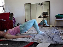 Goddess Aurora Willows does stretching in yoga pants