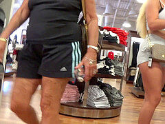 platinum-blonde with taut cut-offs in the candid spy clothing store