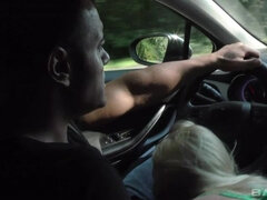 Lola Taylor gives a roadie blowie behind the steering wheel