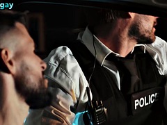 A manly police officer with a tattooed body fucks the bottom guy in the ass