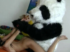 Brunette is fucked by a fella in a panda suit with a strap on