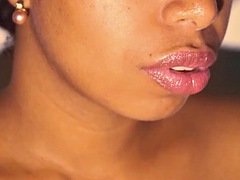 Sexy lips ebony play with her red lipstick close up