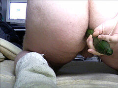 plump dude toying with cucumber