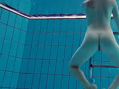 Baby floating in the swimming pool naked
